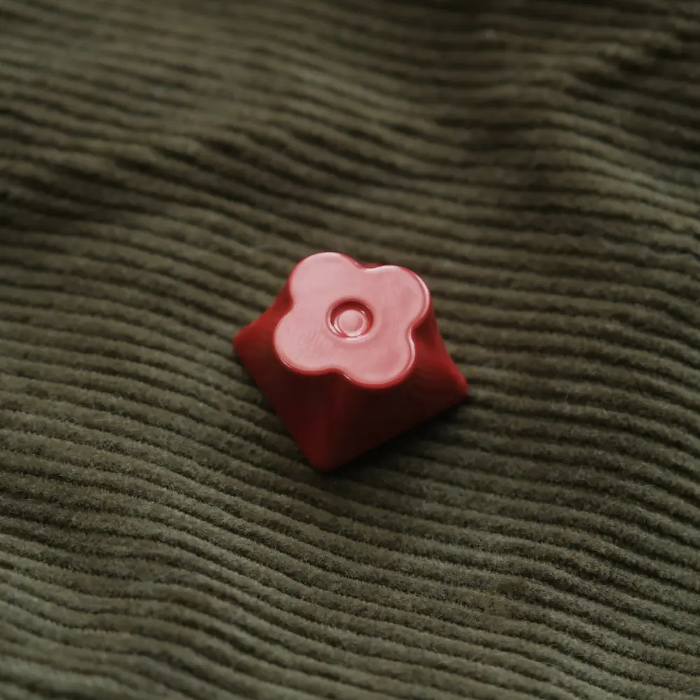 Close-up of a Candy Red CNC machined aluminum flower metal artisan keycap for mechanical keyboards.