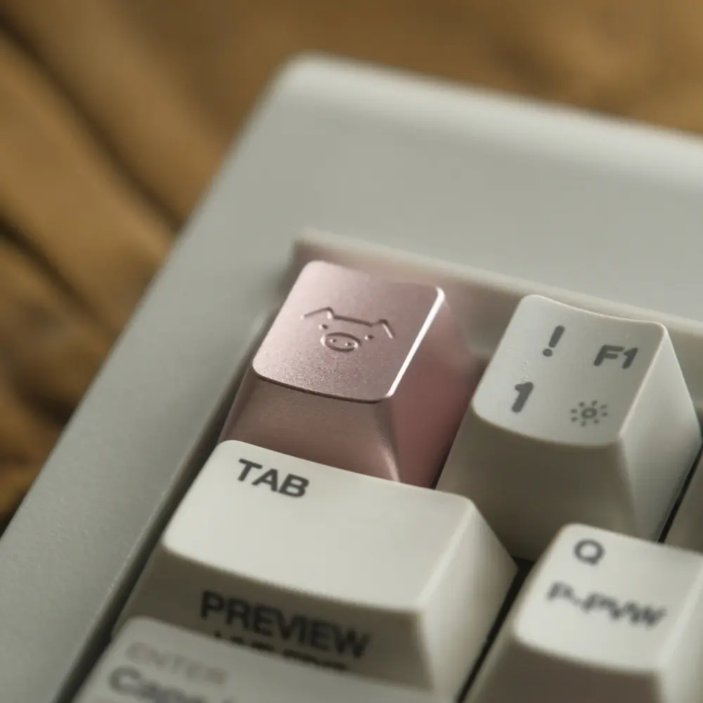 Minimalist pig character engraved on a Blush Pink CNC aluminum metal artisan keycap.