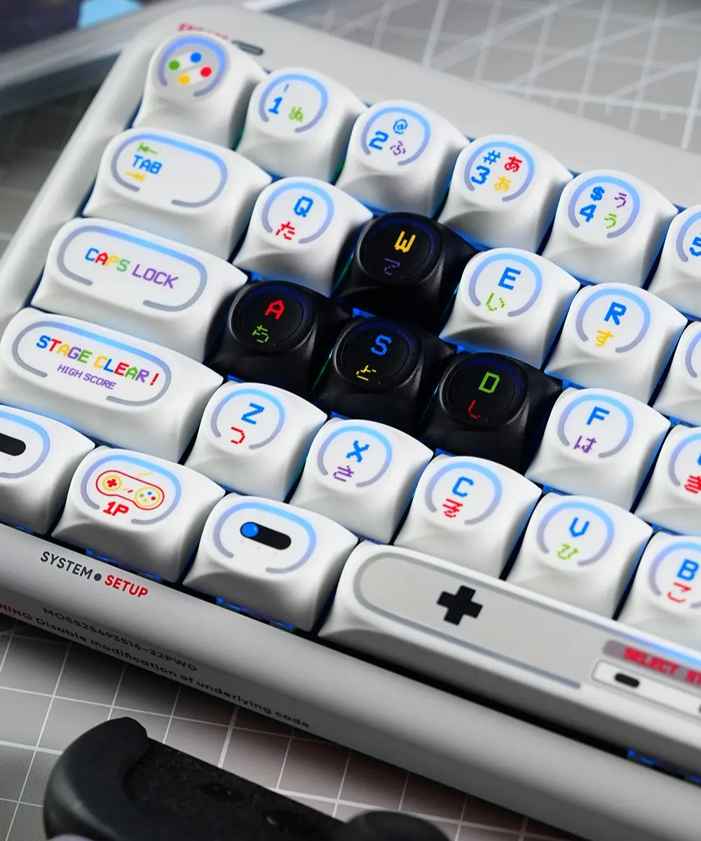 Retro Game Console Theme Keycaps with Black WASD Close-up of Game Console Theme keycaps displaying Stage Clear legend, 1P gamepad icon, and black WASD keys.