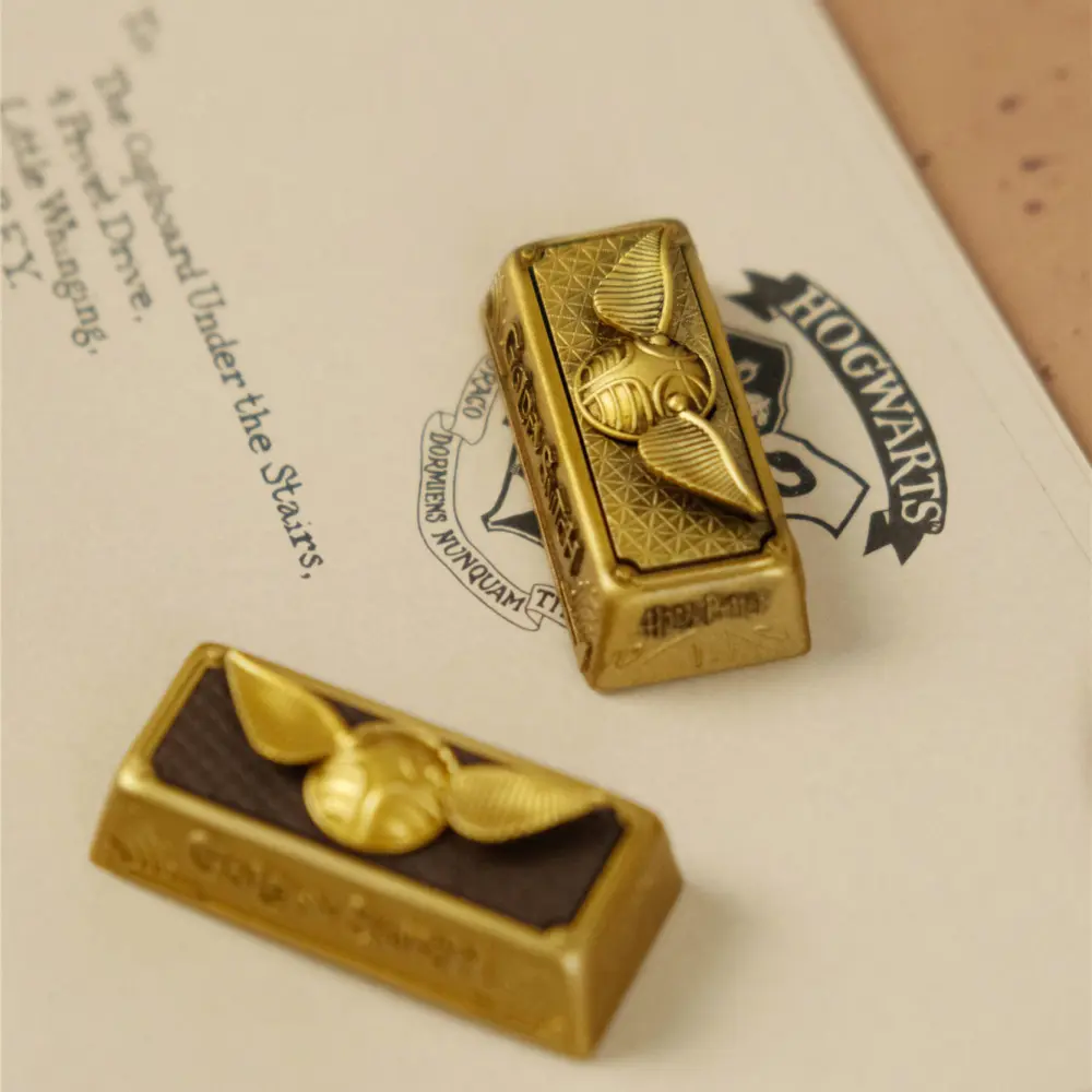 Two 2.25U Enter keycaps featuring the Golden Snitch design on a Hogwarts letter background.