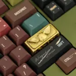 Close-up of the vintage oxidized Harry Potter artisan keycap featuring a 3D Golden Snitch design on a keyboard.