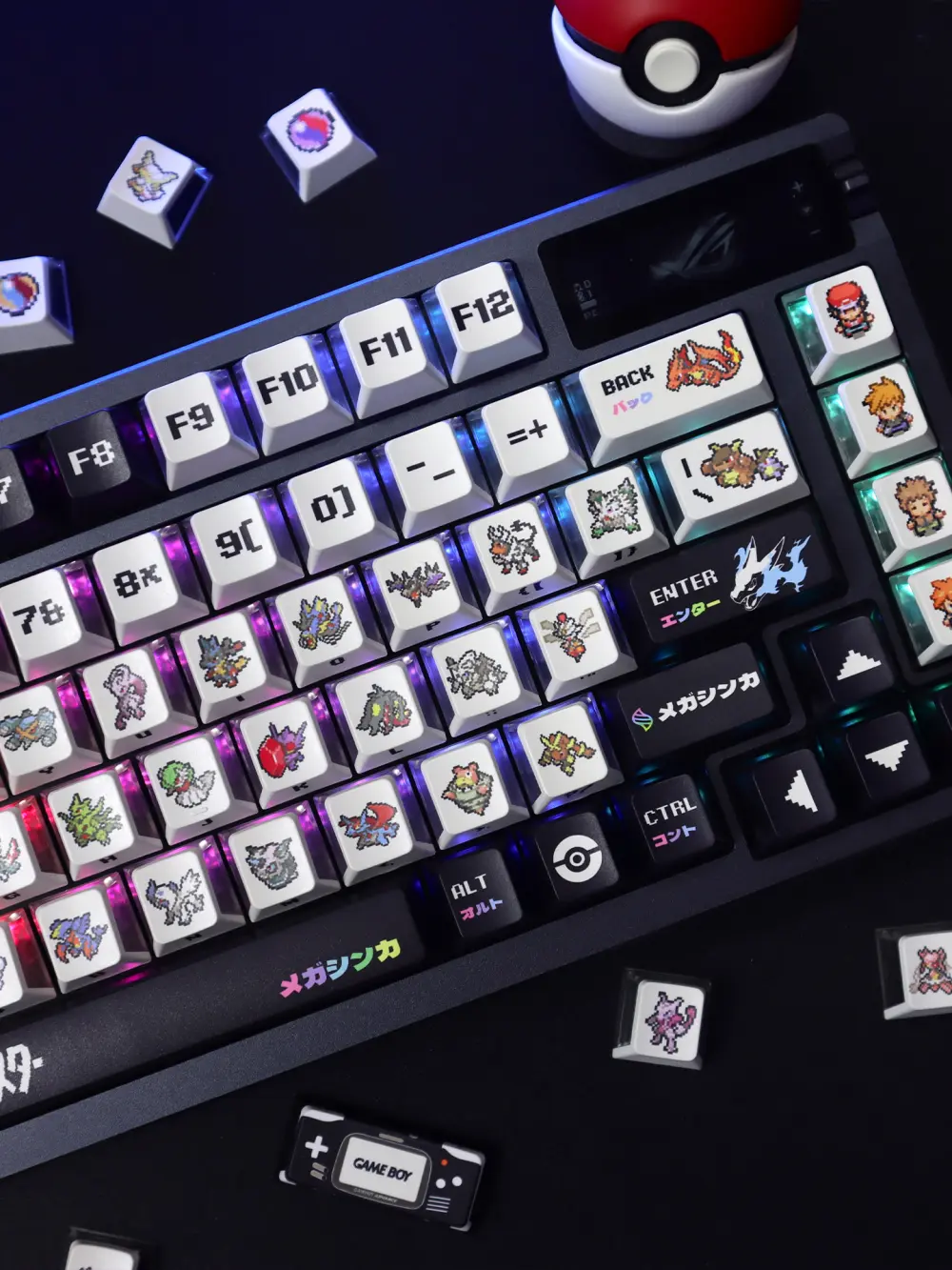 Top view of a keyboard with Pokemon Mega Evolution keycaps and a Pokeball in the background.