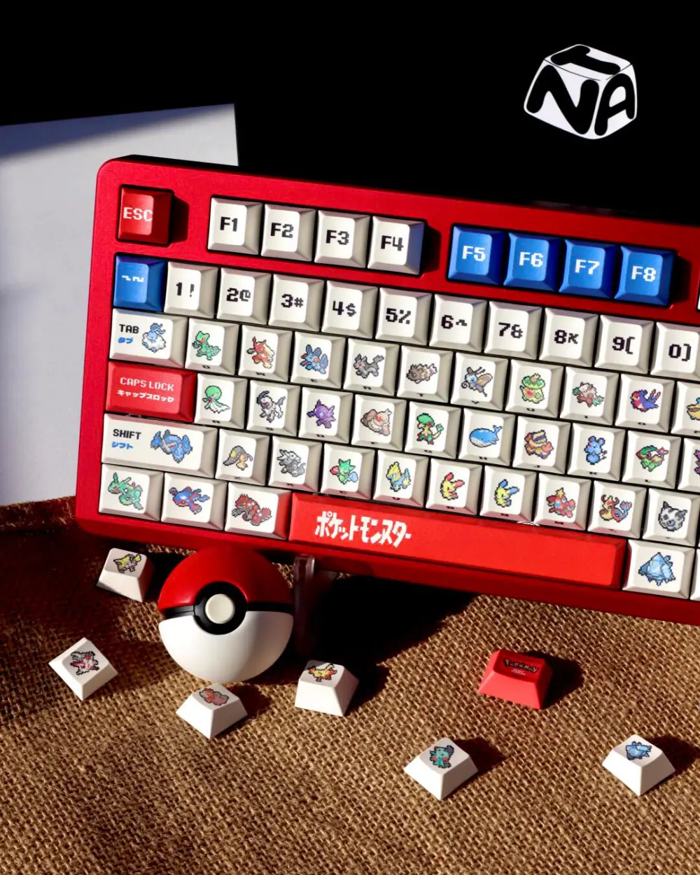 Custom mechanical keyboard with Pokemon Ruby and Sapphire pixel art keycaps on a red aluminum case.