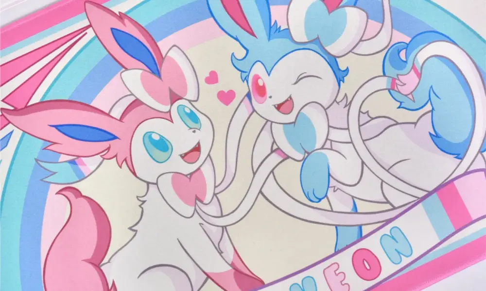 Close-up of pink and blue Sylveon illustrations on the vibrant pastel gaming desk mat.