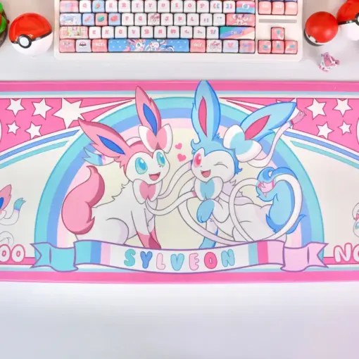 Large gaming desk mat with Sylveon artwork, matching mechanical keyboard, and Pokéball accessories.