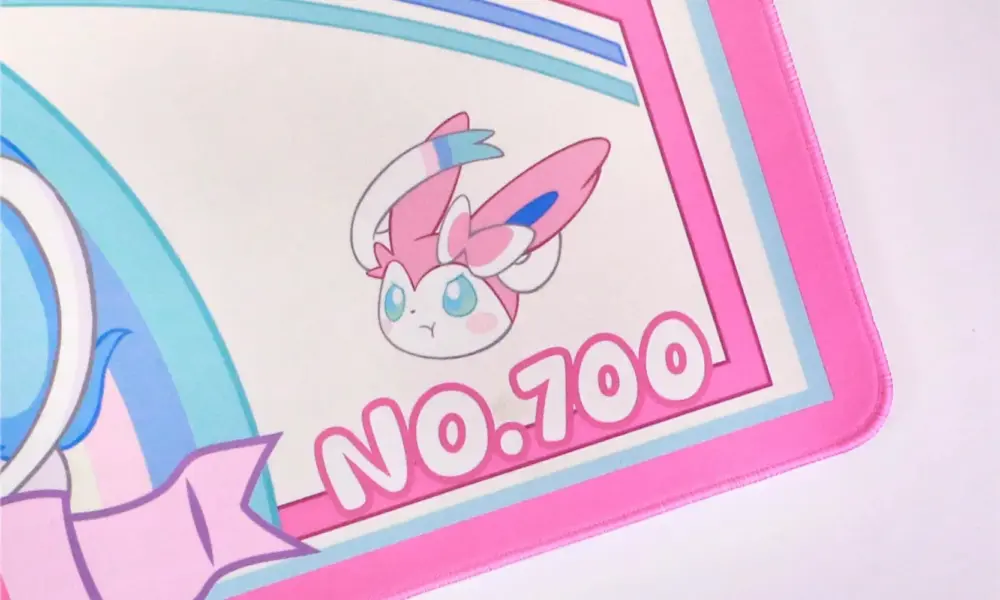 Detailed view of the pink Sylveon gaming desk mat with a cute Pokemon head illustration and No. 700 text.