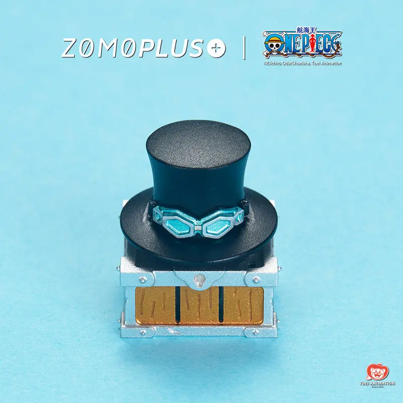 ZOMOPLUS One Piece Sabo’s Hat Rotating Aluminum Artisan Keycap ZOMOPLUS One Piece Sabo Hat artisan keycap featuring a black top hat and metallic chest base.