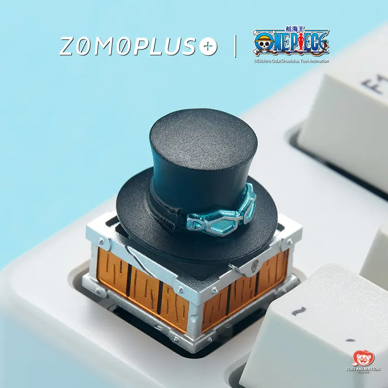 ZOMOPLUS One Piece Sabo’s Hat Rotating Aluminum Artisan Keycap ZOMOPLUS One Piece Sabo hat aluminum keycap featuring a black top hat on a detailed treasure chest base.