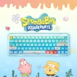 Top-down view of spongebob keycaps on a light blue keyboard with Patrick and SpongeBob graphics.