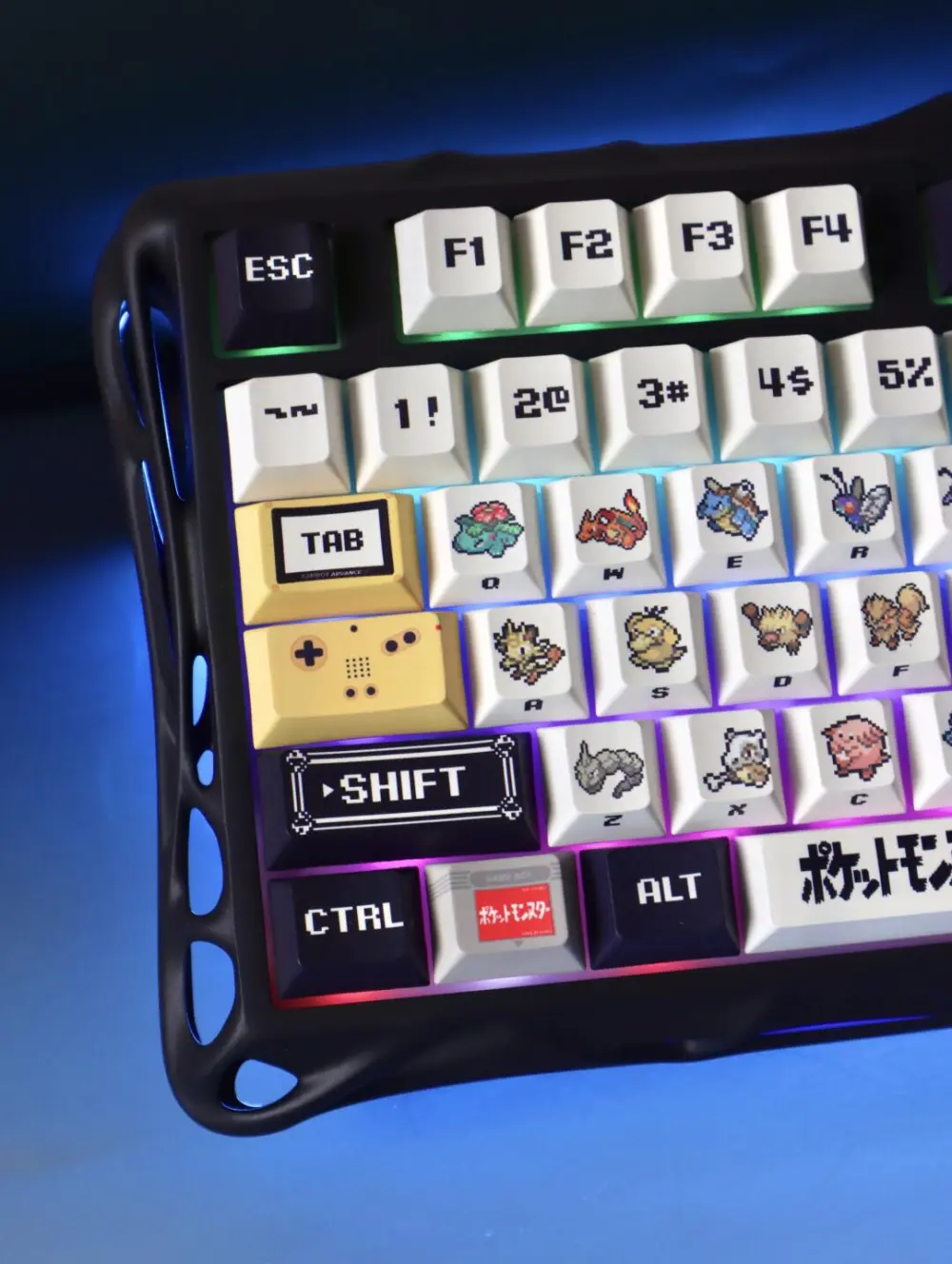Pokemon Red and Green pixel cherry profile keycaps on a backlit keyboard showing Bulbasaur, Charmander, and Squirtle.