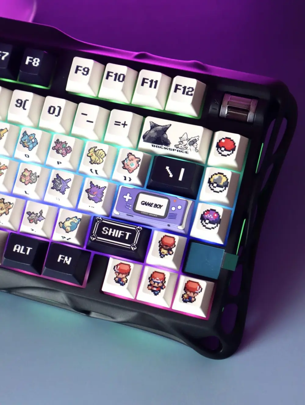 Close-up of Pokemon Red and Green pixel keycaps on a black keyboard with RGB backlighting.