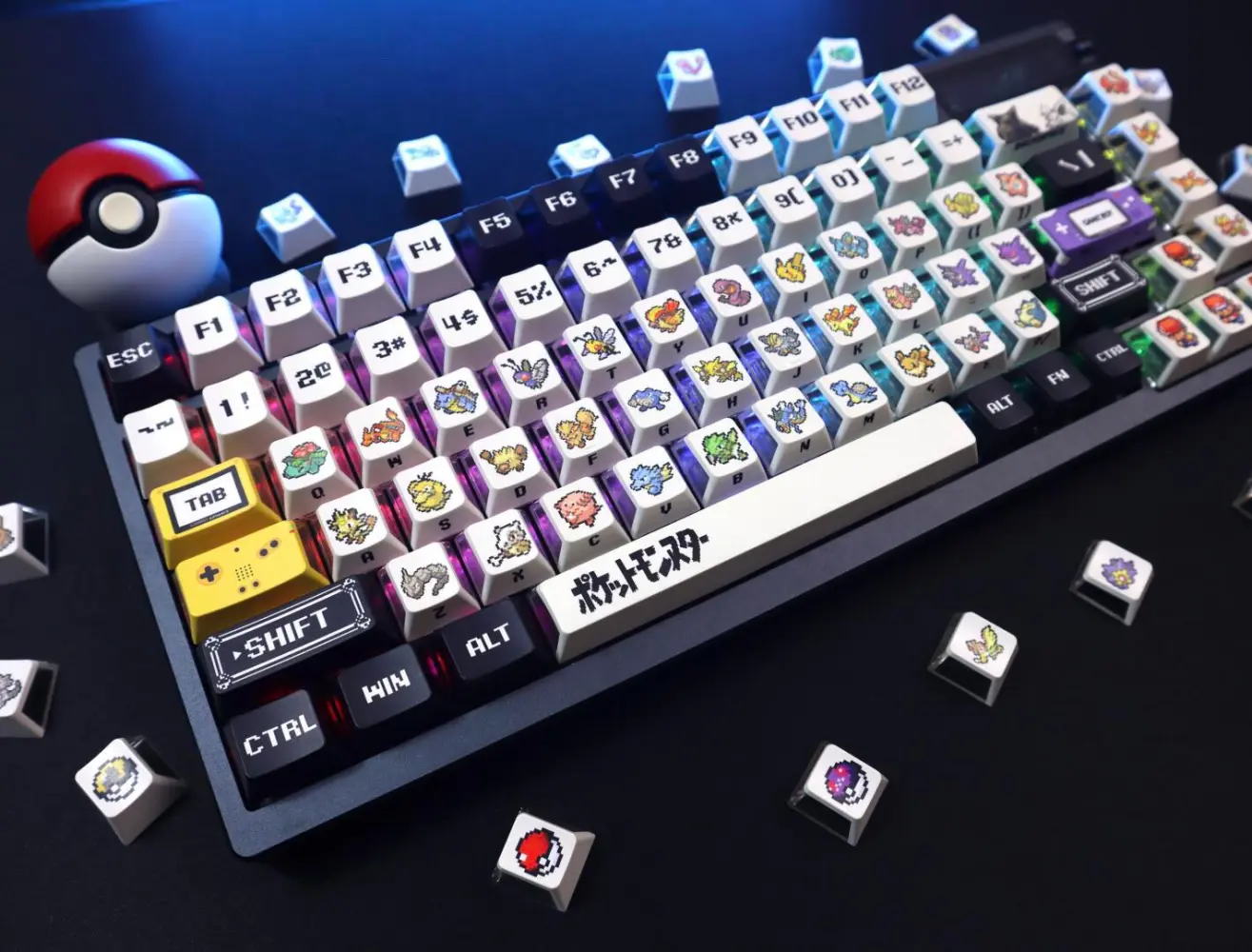 Fully assembled keyboard with Pokemon three-side translucent keycaps and a Pokeball prop on a dark desk.
