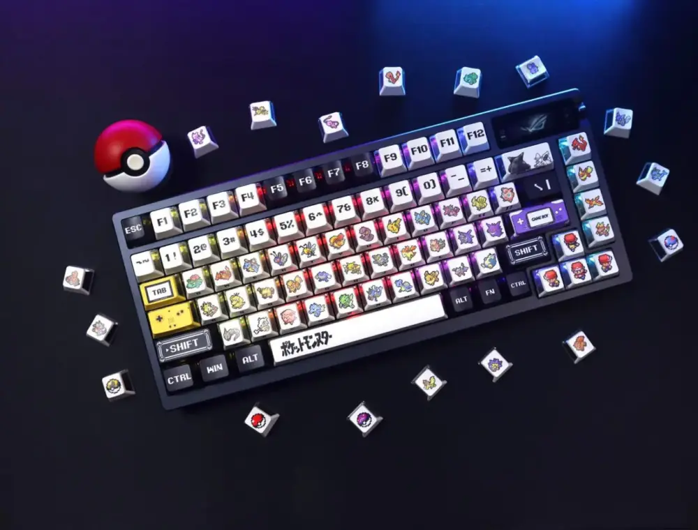 Top down view of Pokemon three-side translucent keycaps on an RGB keyboard next to a Pokeball.