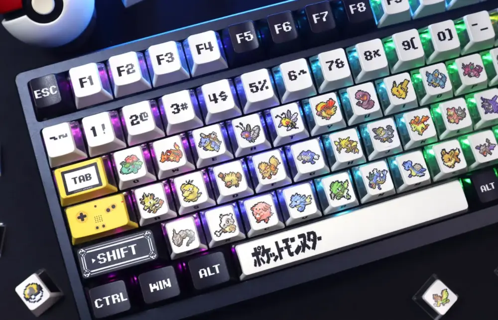 Close-up of Pokemon three-side translucent keycaps showing retro pixel art and RGB backlighting on a keyboard.