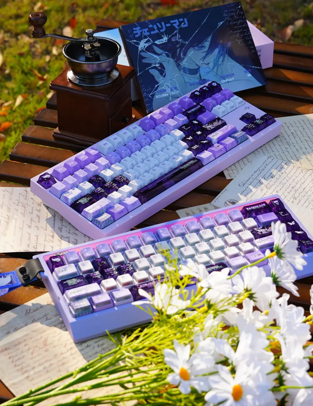 Chainsaw Man Reze Keycaps Outdoor Display Purple and white Reze keycaps on two keyboards, styled outdoors with a vintage coffee grinder and Reze character box.