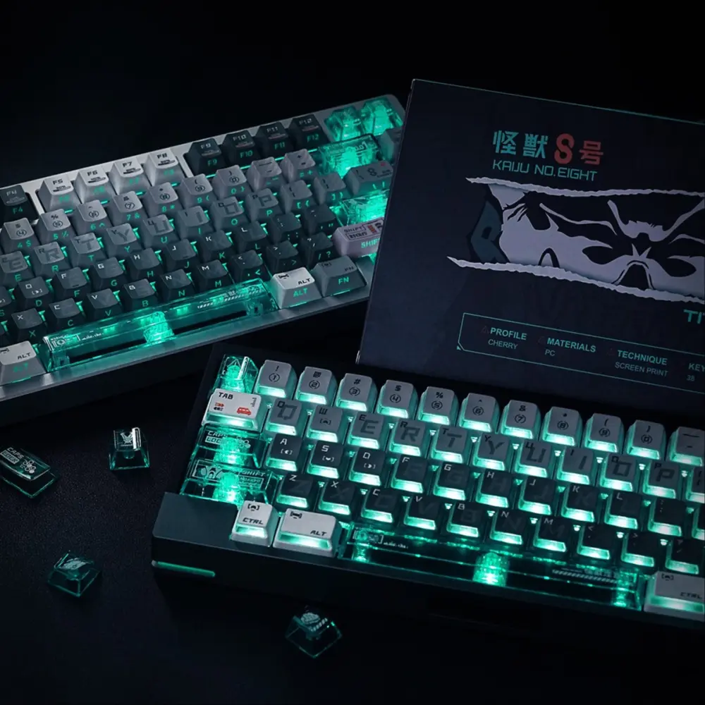 Kaiju No. 8 Nuclear Power side-lit keycaps on two illuminated keyboards showing green RGB next to product box.