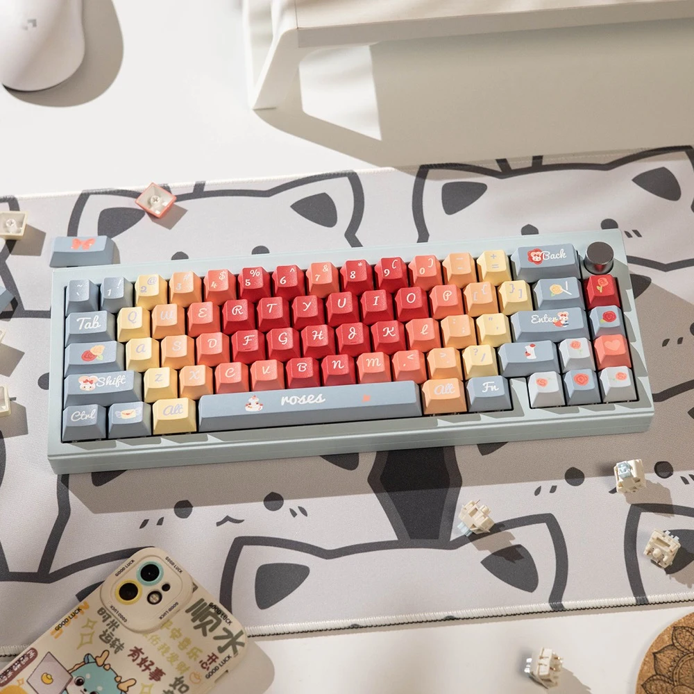 Overhead view of Roses Poem PBT keycaps on keyboard with pastel red, orange, yellow and gray keys, butterfly and bear novelty keycaps