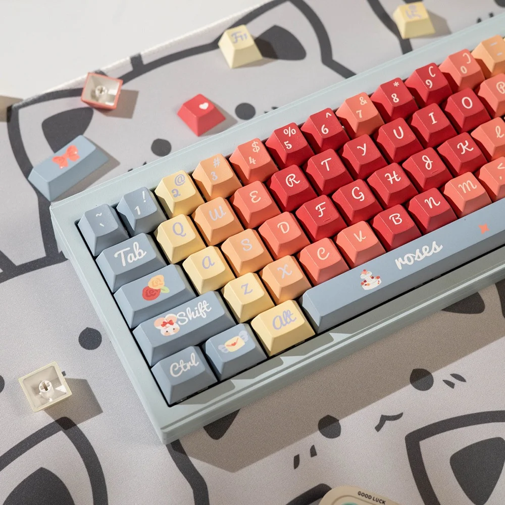 Roses Poem PBT keycaps on patterned surface with scattered extra keycaps featuring kawaii cartoon designs