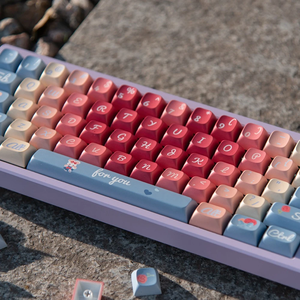 Roses Poem PBT keycaps on light purple keyboard frame with pastel red, pink, blue and beige keys, for you spacebar, and decorative hearts and bunny