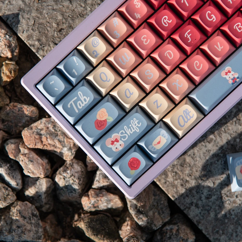 Roses Poem PBT keycaps on rock surface angled overhead view with kawaii cartoon novelty keycaps visible
