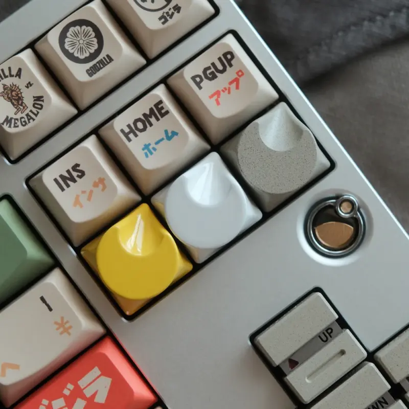 Aluminum artisan keycaps in three finishes shown installed on a mechanical keyboard with custom surrounding keycaps.