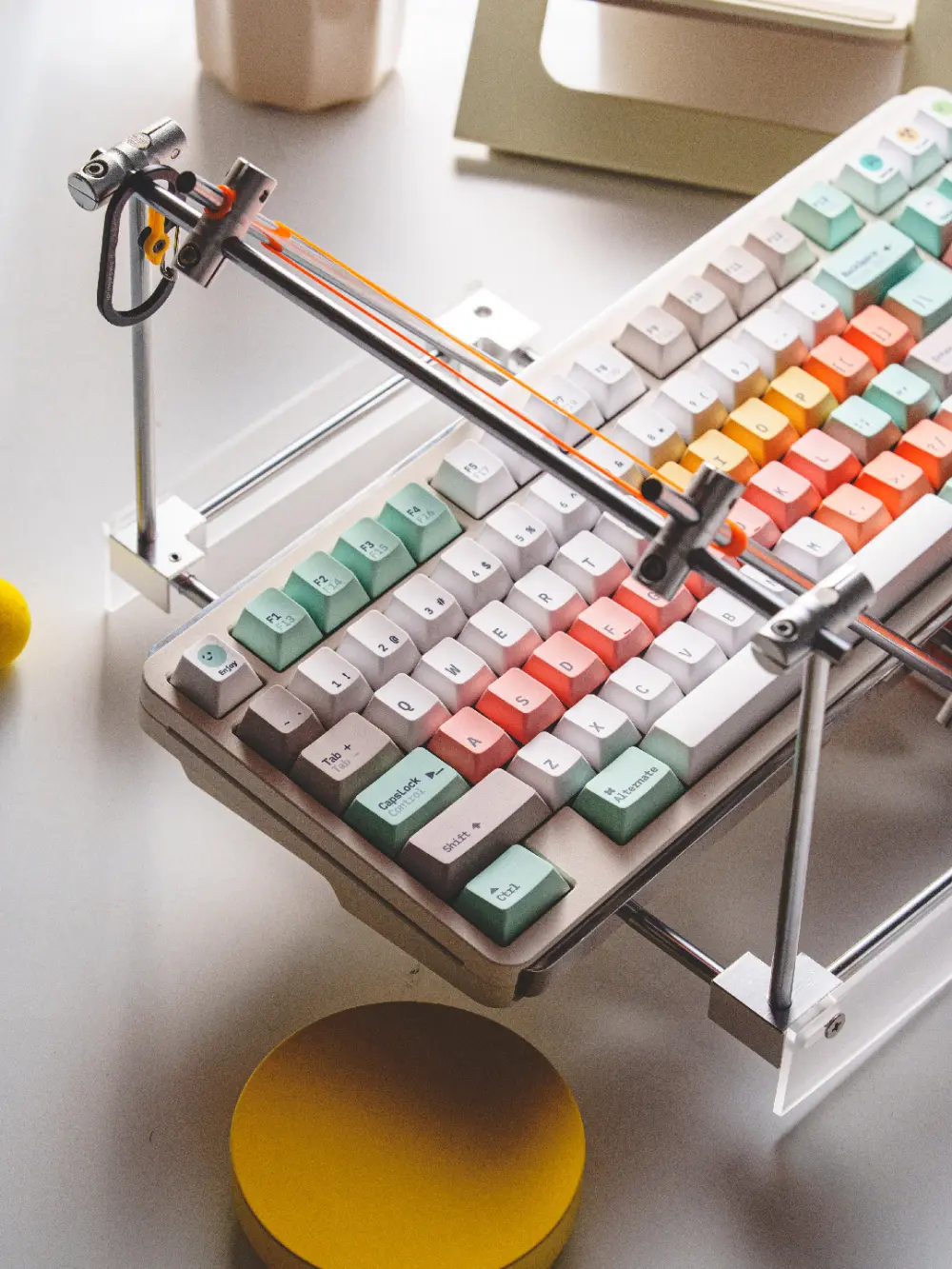 Fantasy Bean Y2K Keycaps on Keyboard with Metal Stand Fantasy Bean Y2K PBT keycaps in a color mix of green, grey, and peach on a mechanical keyboard.