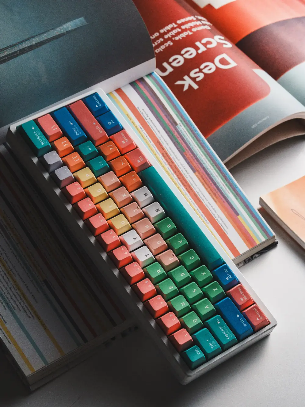 Fantasy Bean Y2K Style PBT Cherry Profile Keycaps on Open Magazine Fantasy Bean Y2K PBT Cherry profile keycaps with gradient colors resting on a magazine.