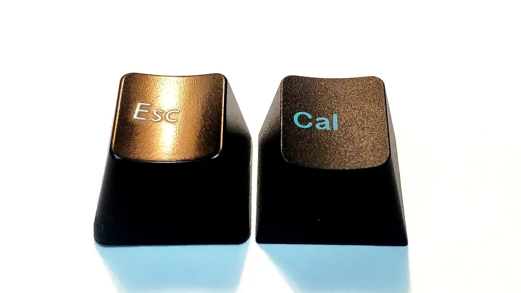 Side-by-side close-up of a PBT keycap showing fine matte texture next to an ABS keycap showing glossy shine from finger oil wear