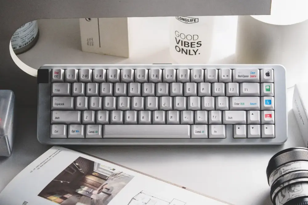 Retro Mac Keycaps Installed on Keyboard White Mac keycaps with classic Apple logo and retro modifier keys shown on a compact desktop keyboard.