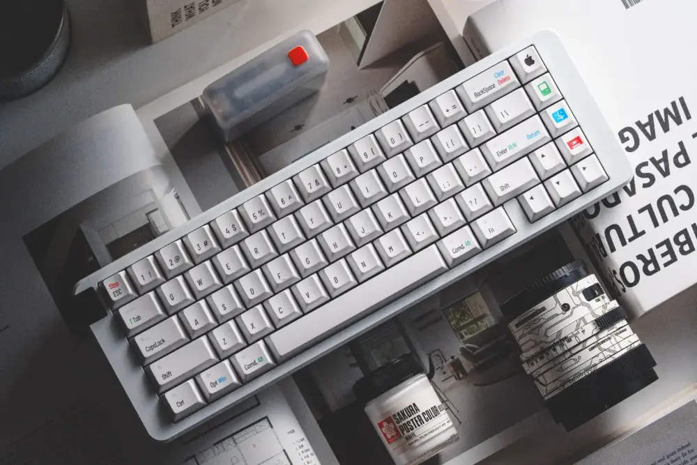Retro Mac Keycaps Desk View Top-down view of a white keyboard featuring vintage Mac-specific keycap legends and symbols.
