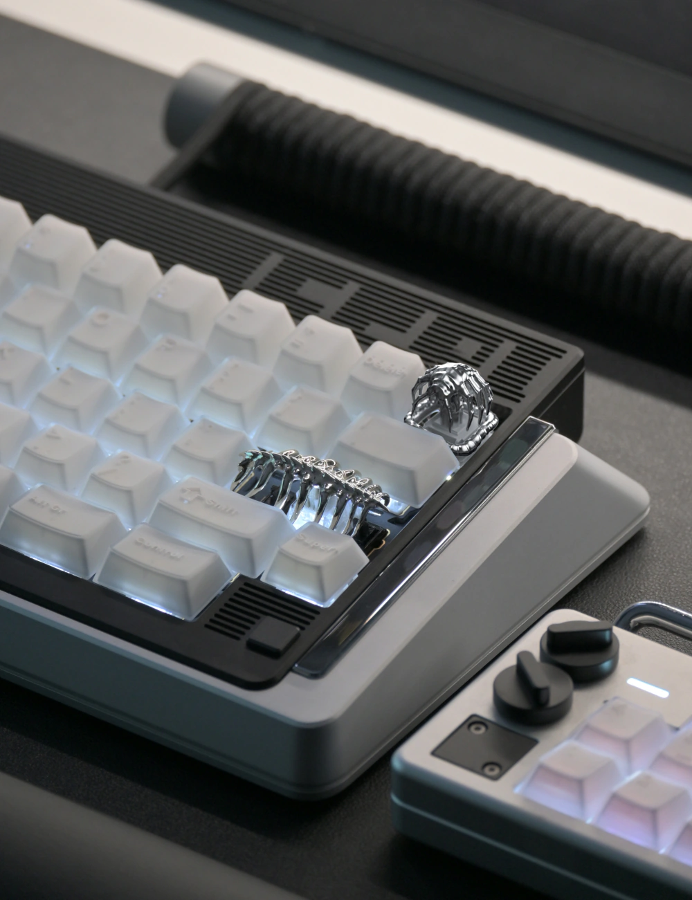 Alien Facehugger Keycap Mounted Silver metal alien artisan keycap attached to a white backlit mechanical keyboard.
