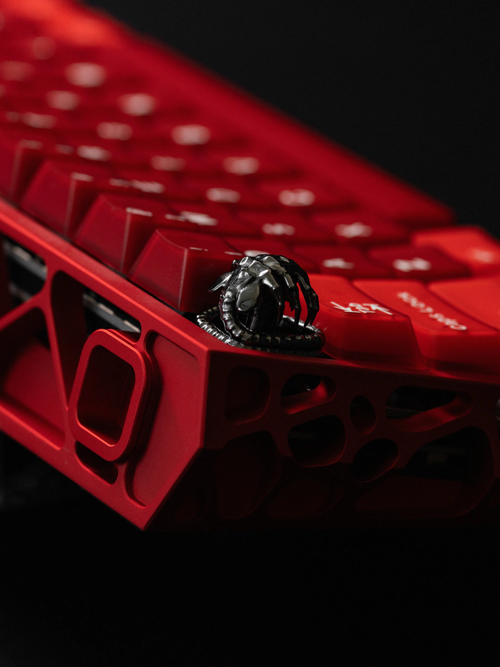 Alien Facehugger Keycap on Red Keyboard Close-up of the silver alien facehugger artisan keycap installed on a red keyboard.