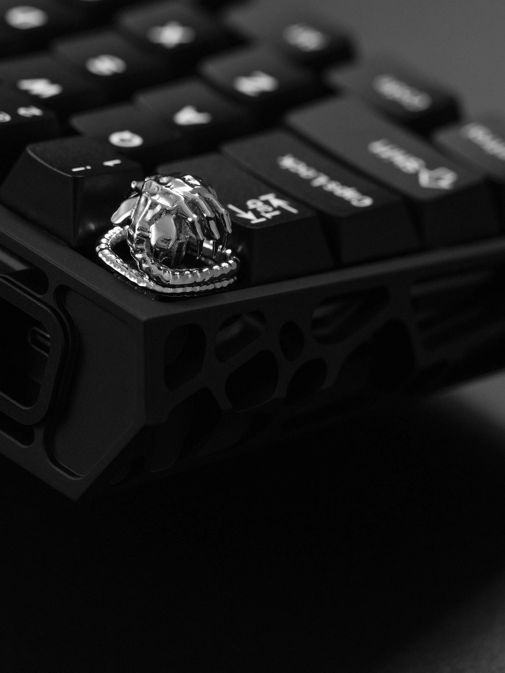 Silver Alien Facehugger Keycap Macro shot of silver alien artisan keycap showing metal tail and claws on keyboard.