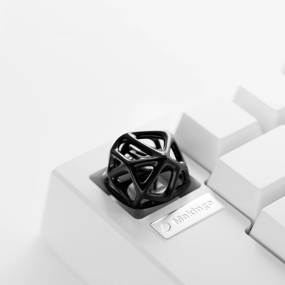 Black Hollow Metal Artisan Keycap on Keyboard Futuristic black hollow metal artisan keycap with organic cell lattice design on a white keyboard.
