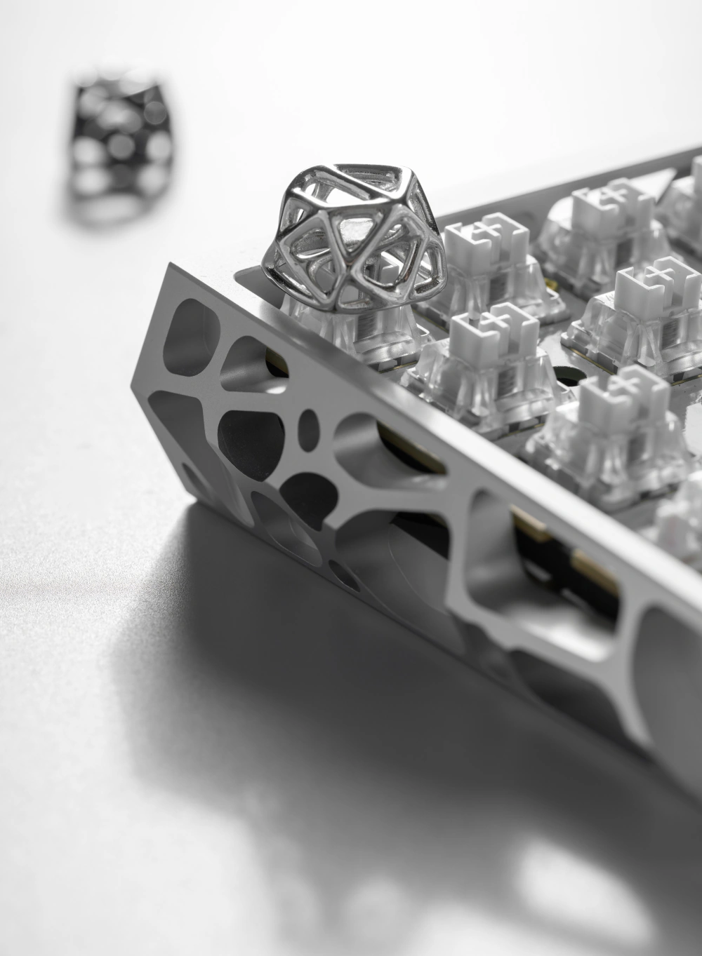 Platinum Futuristic Hollow Metal Artisan Keycap Platinum hollow metal artisan keycap on a keyboard switch with matching lattice metal case.
