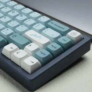 Close-up of blue XDA keycaps with a white mountain accent key and arrow keys