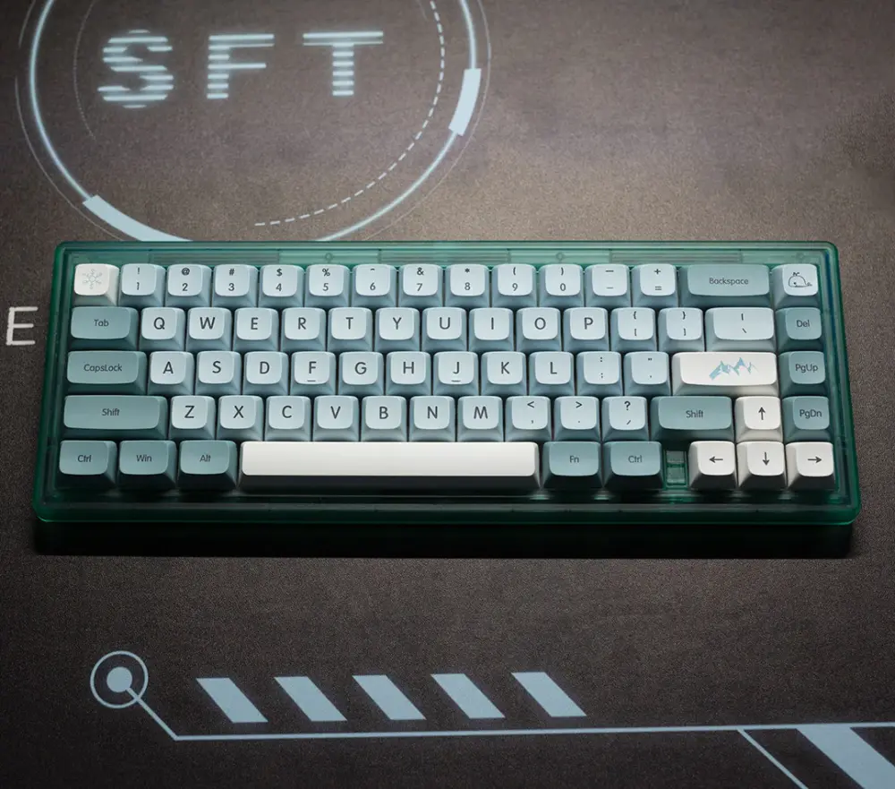 Compact keyboard with blue and white keycaps on a dark desk mat from the front