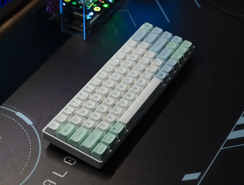 Compact keyboard with Ice Crystal XDA keycaps viewed diagonally on a dark mat.
