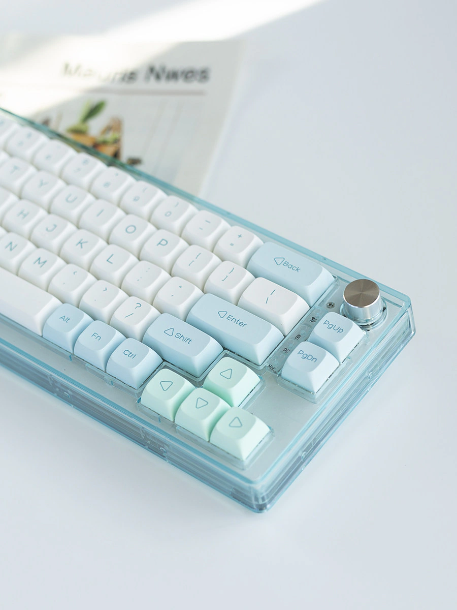 Right side of a keyboard with white, mint, and pale blue XDA keycaps.