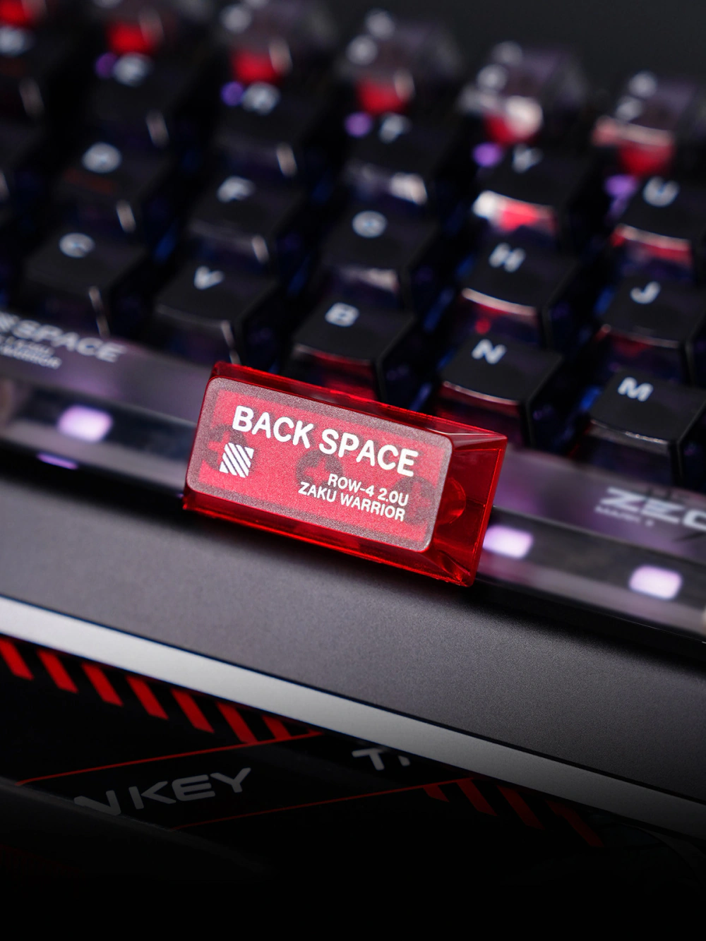 Red translucent PC Back Space keycap with matte top and printed legends.