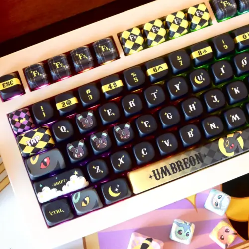 Moonlit Companion keycaps in black and warm gold with rounded MOA profile and decorative accents.