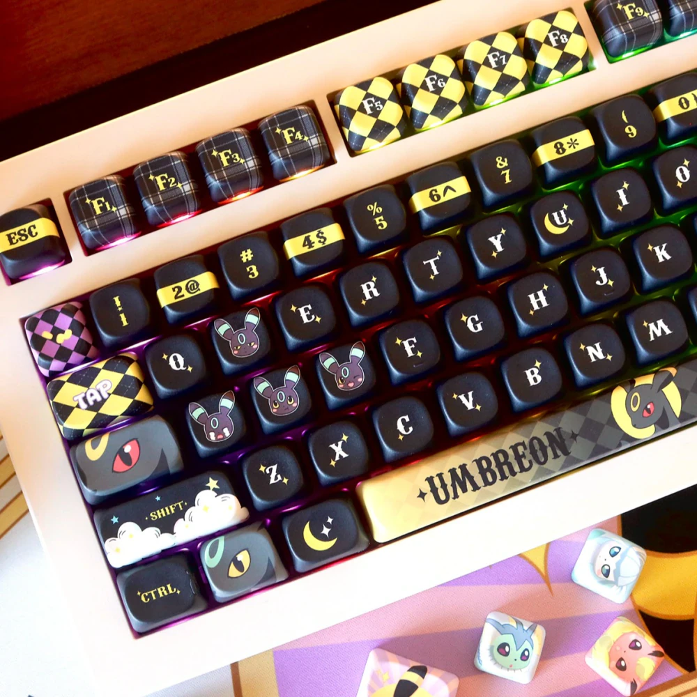 Moonlit Companion keycaps in black and warm gold with rounded MOA profile and decorative accents.