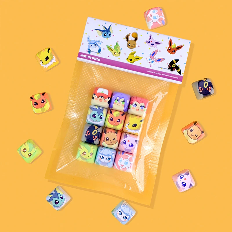 Top-down view of decorative character keycaps sealed in plastic packaging.