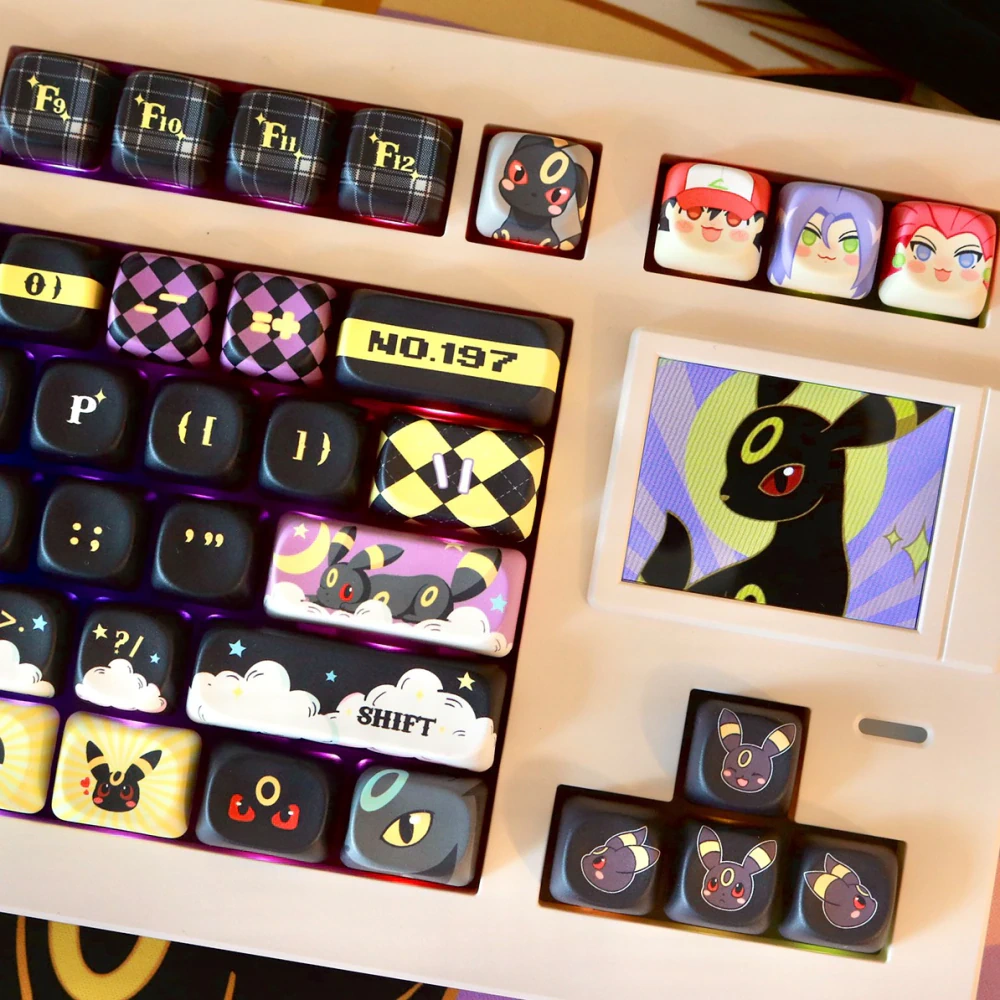 Moonlit Companion MOA keycaps in black and warm gold on cream keyboard with character accent keys and arrow cluster.