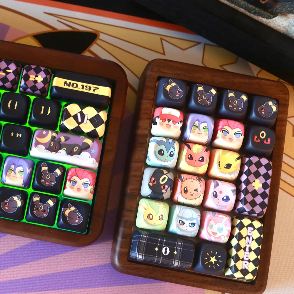 Moonlit Companion MOA keycaps installed on two wooden numpads with black and gold decorative accents.