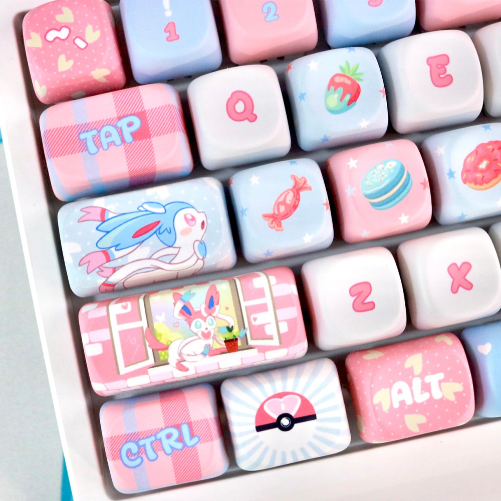 Left-side view of Pastel Dream Companion MOA Profile keycaps with pink and blue ribbon characters, candy, and heart icons.