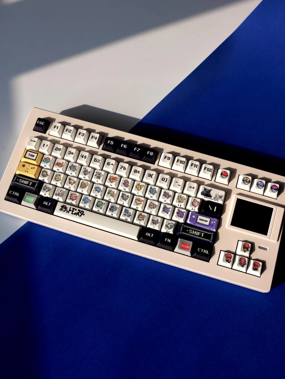 Beige mechanical keyboard fitted with retro red and green pixel art keycaps.