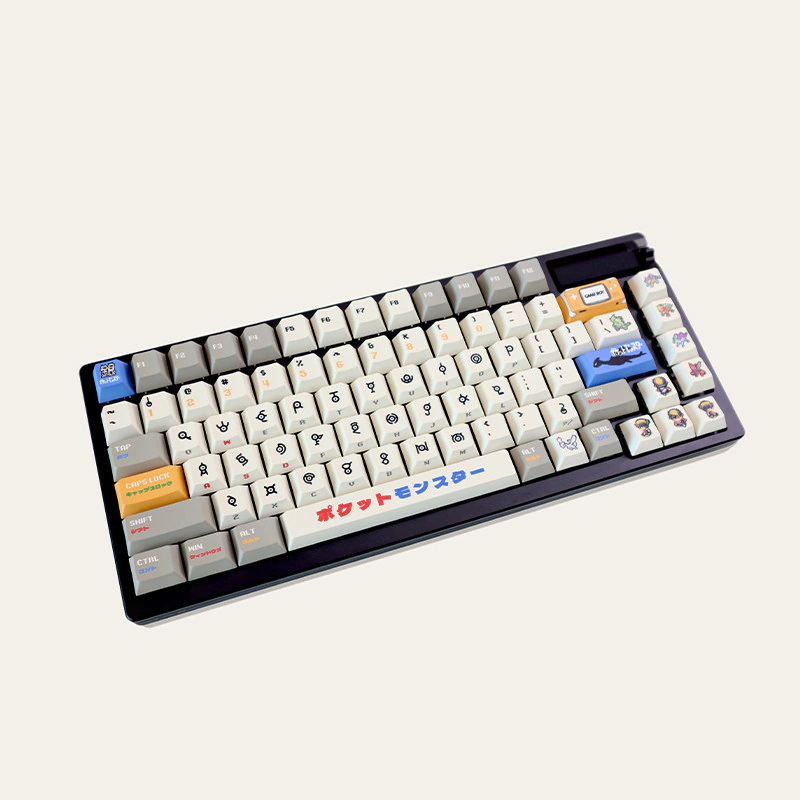 Retro gold silver pixel keycaps on dark keyboard angled right showing Japanese spacebar and pixel symbol legends.