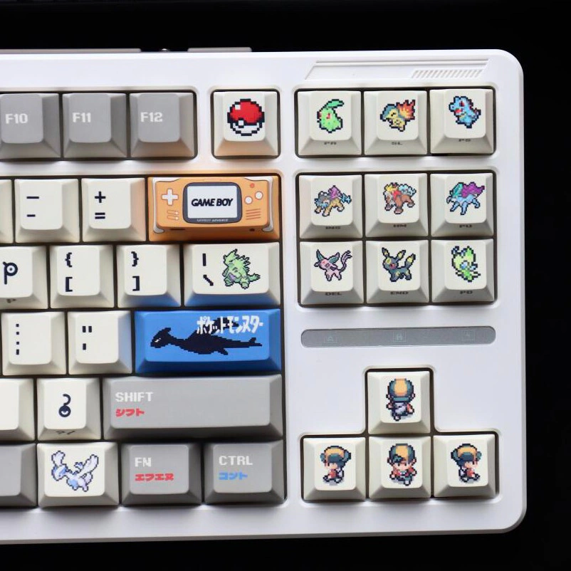 Grey white gold pixel keycaps with retro character sprites and Game Boy accent.