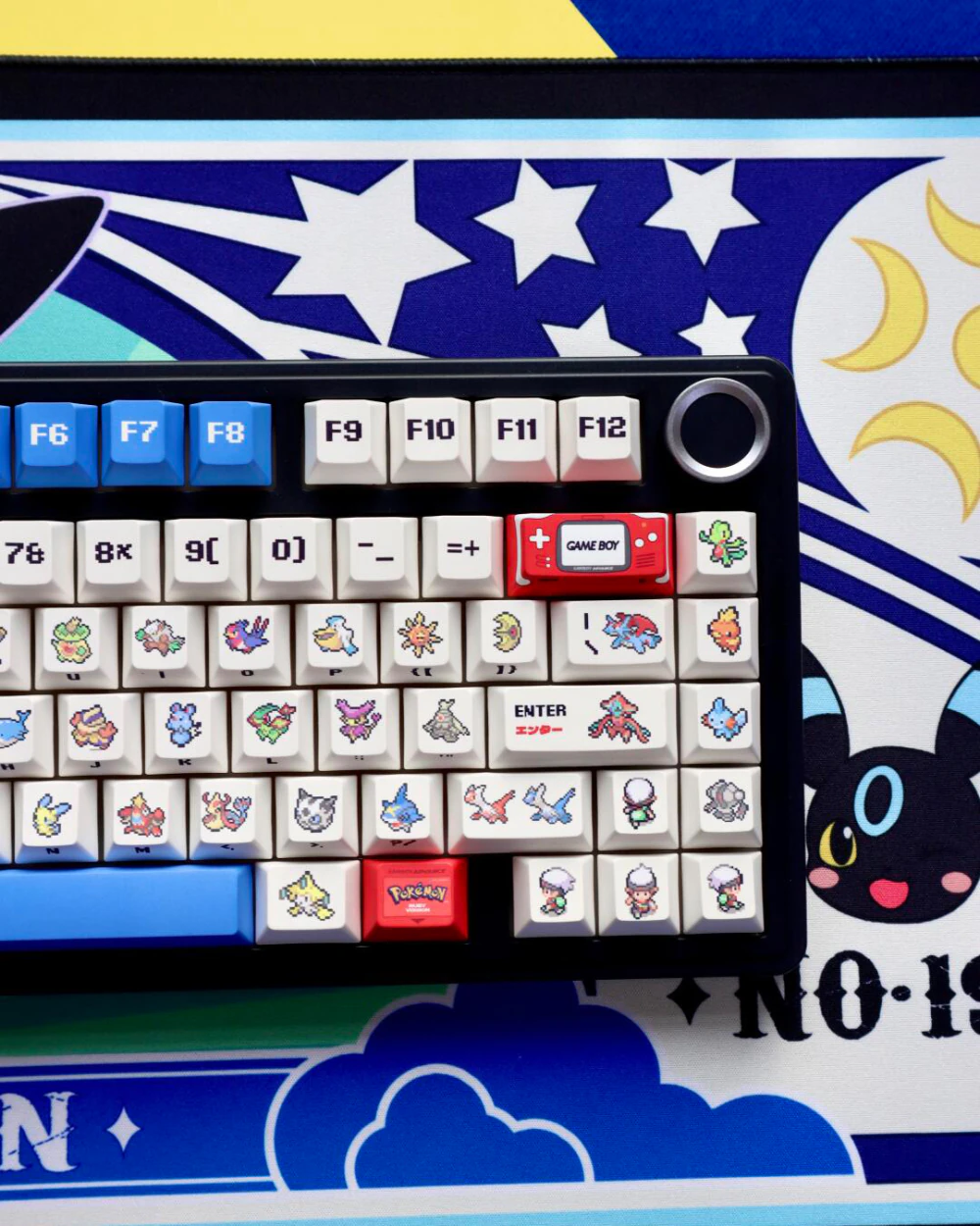 Cherry profile keycaps with 8-bit pixel sprites installed on black mechanical keyboard with blue spacebar and red accents.